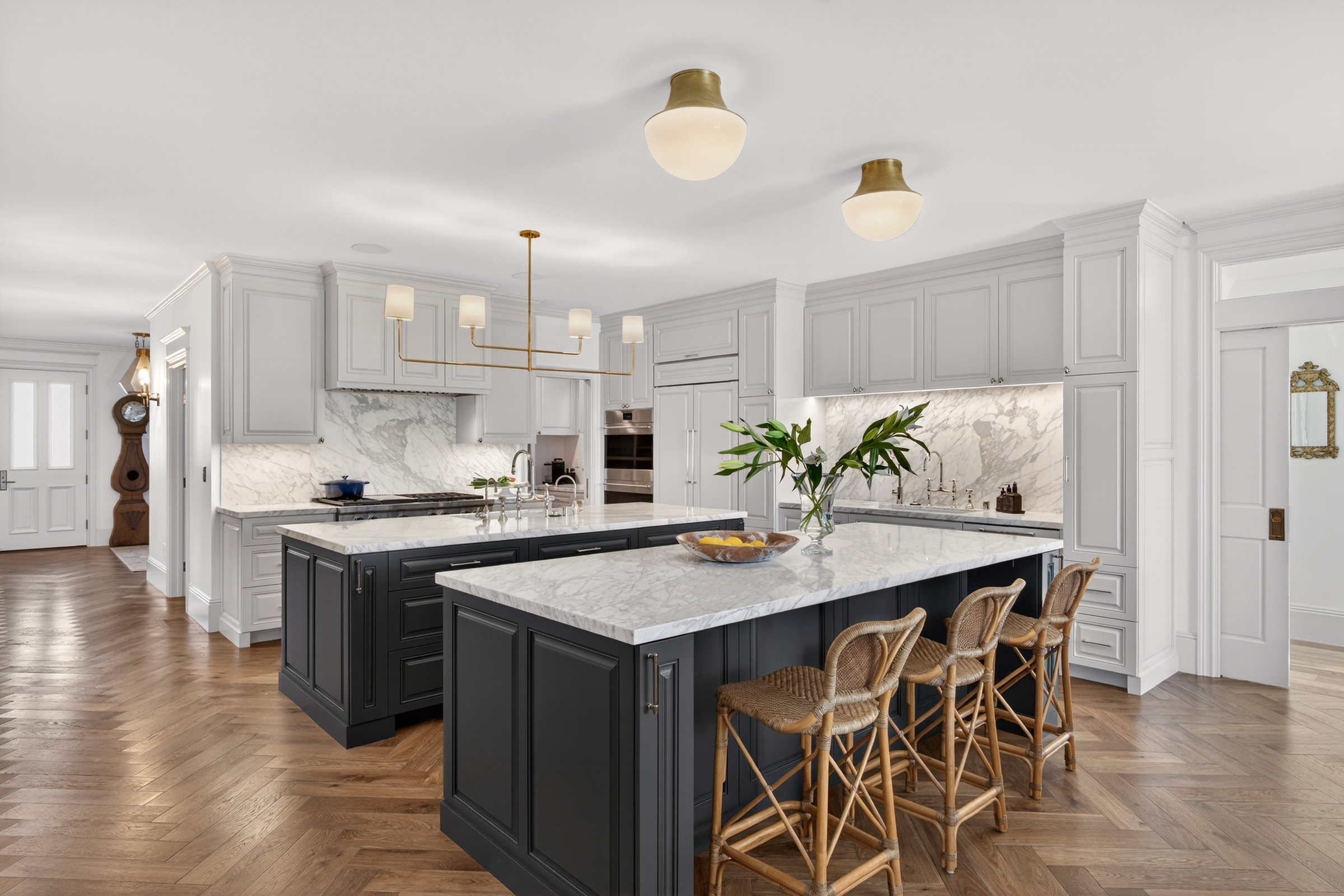 Kitchen with dark island and brass fixtures