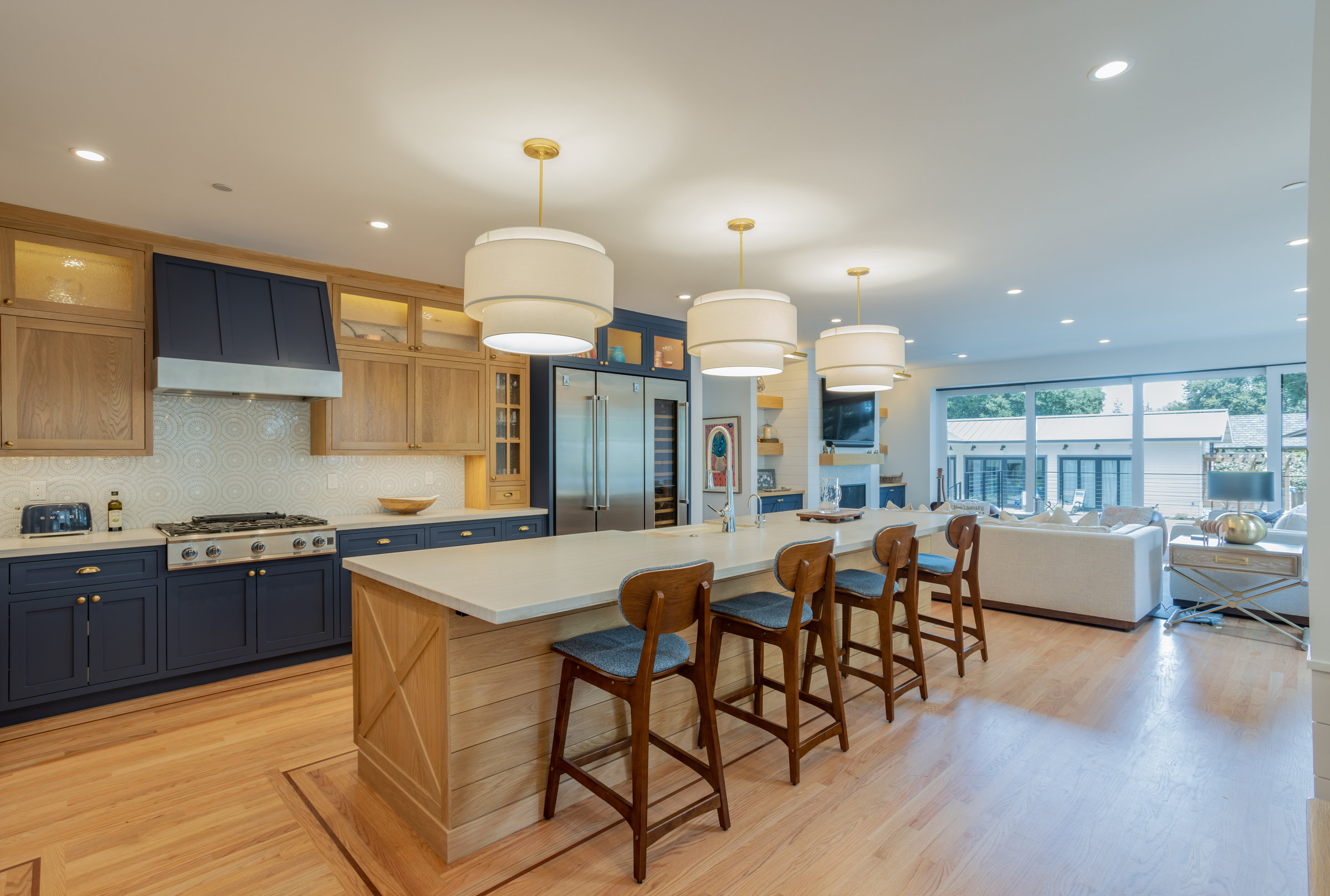 Kitchen with navy cabinets and oak island