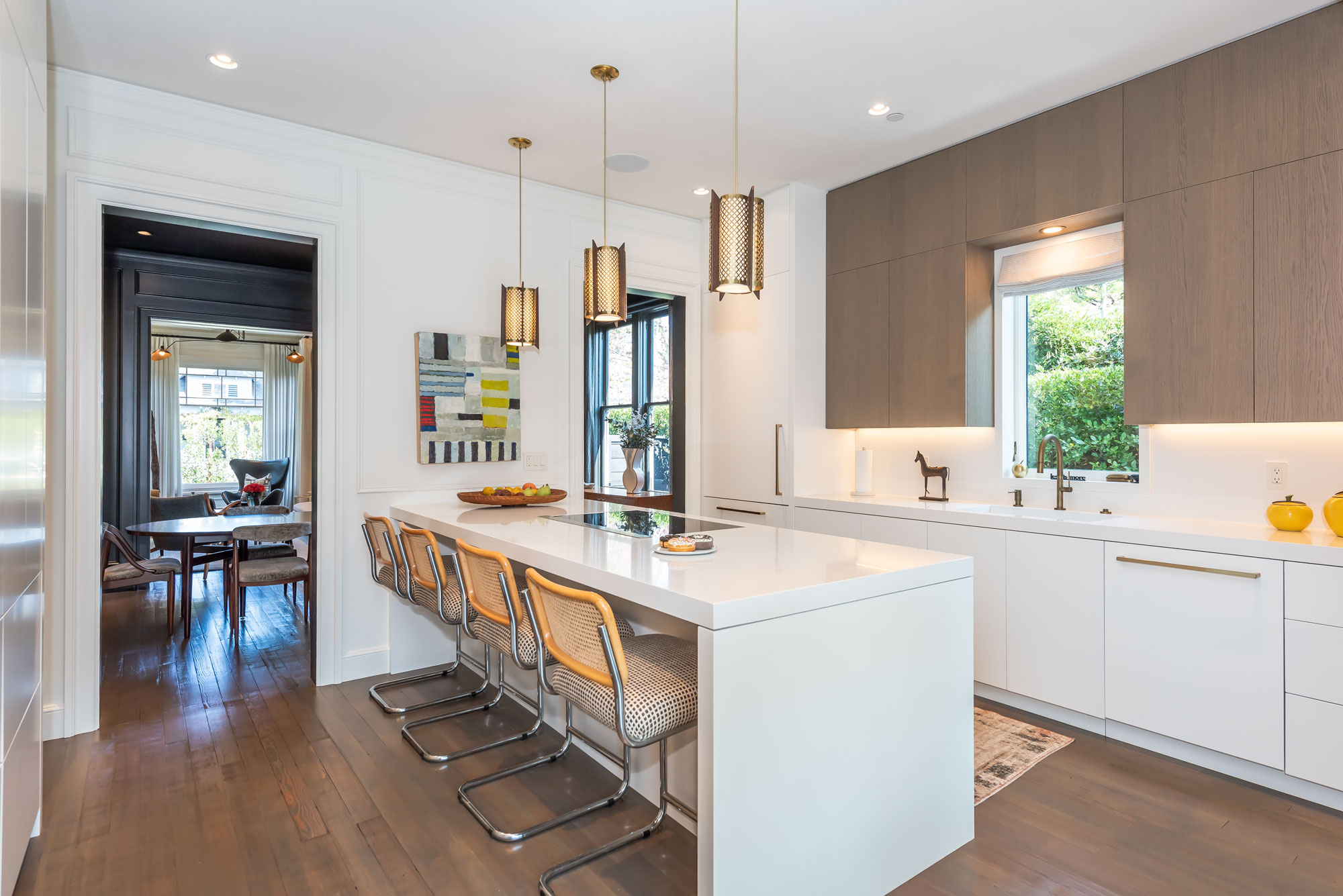Kitchen with white cabinetry and brass fixtures