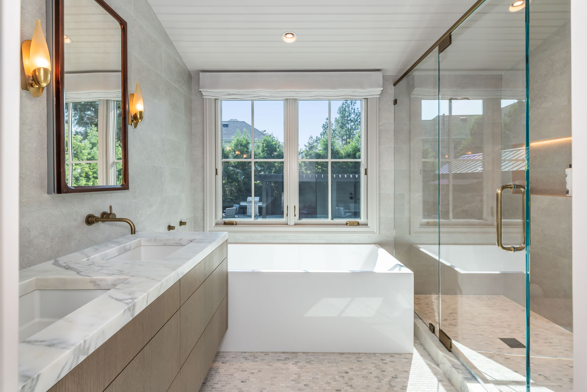 Primary bathroom with marble and brass